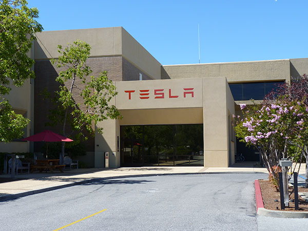 Photograph of the entrance to a building with the Tesla logo on it.