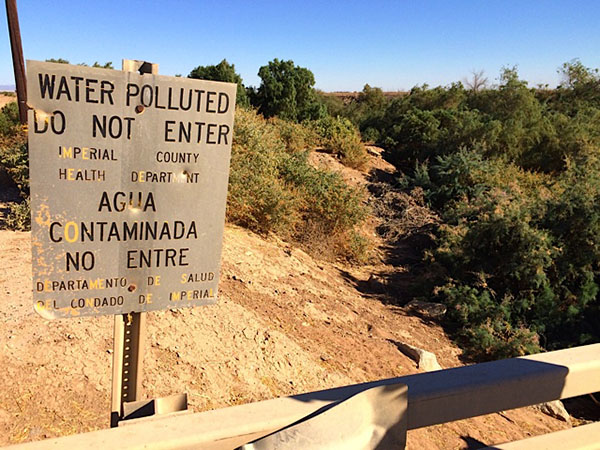  A sign warns residents not to risk contact with agricultural runoff flowing through one of the small rivers feeding the Salton Sea.