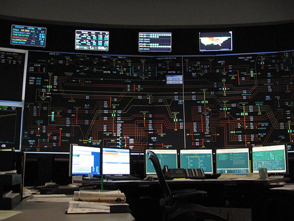 Photograph of a control room filled with screens and displays.