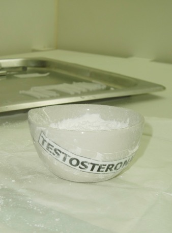A bowl labelled "Testosterone" is filled with a white powder.