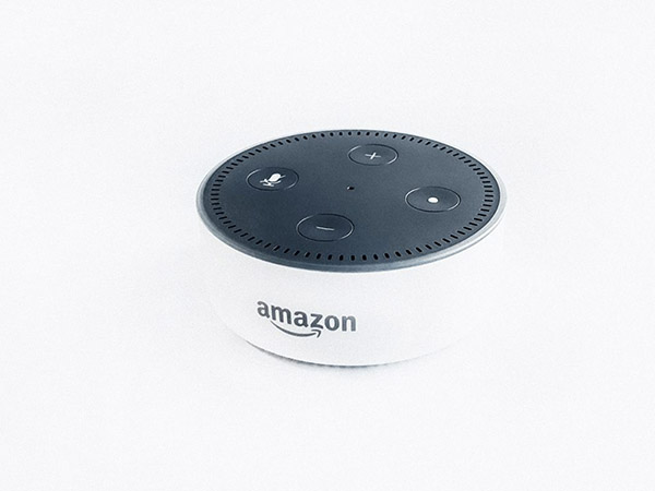 Photo of Amazon's Echo Dot, a small, white voice-activated digital assistant
