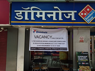 A banner outside a Domino's pizza franchise in India seeking delivery personel reads: VACANCY: (Only for boyys)