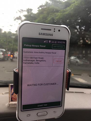 A smartphone displays an Uber driver's pickup screen. The screen reads "Waiting for customer"