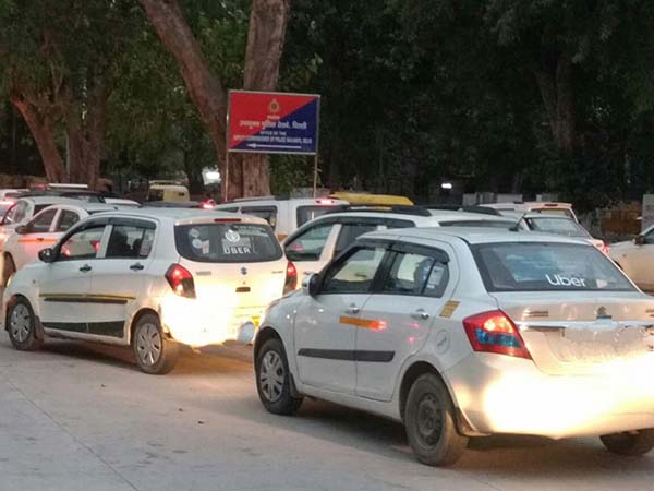 A congested road full of white, ride-sharing cars