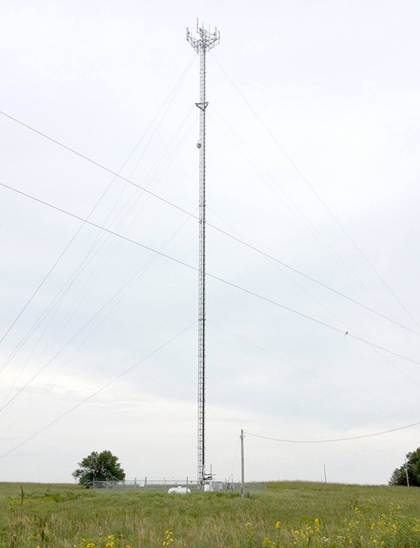 Color photo of a wireless internet cell tower behind the Bazaar Cemetery in the Flint Hills region of Chase County, Kansas.