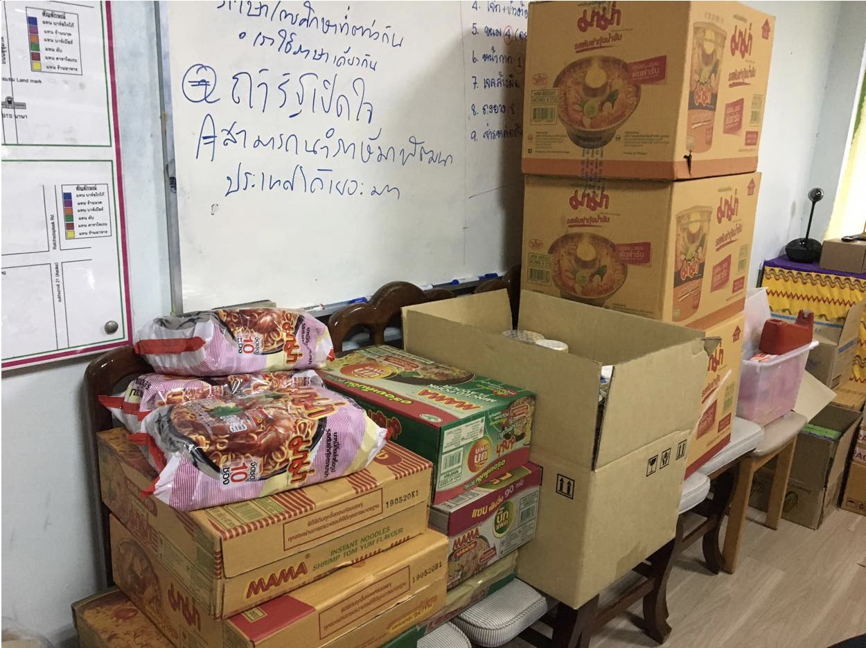 Boxes of Mama noodles sit upon chairs in a SWING community center office. Photo Credit: SWING Organization.