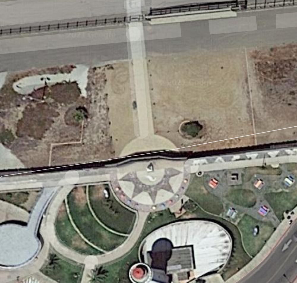 Aerial view showing two border walls parallel to each other bisecting Friendship Park and El Parque de La Amistad.