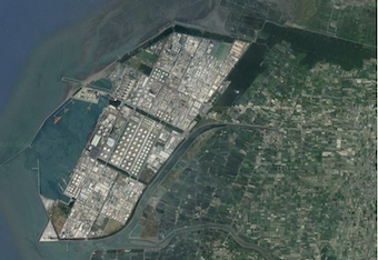 A satellite view of the Sixth Naptha Cracking Plant in Mailiao, Yunlin on Taiwan, showing coastline, the megaproject, and the surrounding rural settlements.