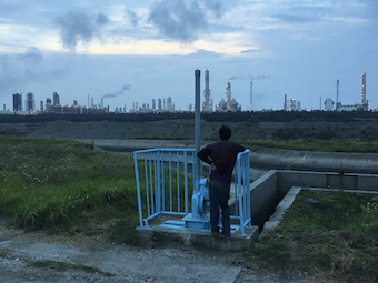 A businessman looks over the horizon to observe the Naphtha Sixth Cracking Plant in Mailiao, Yunlin, Taiwan.