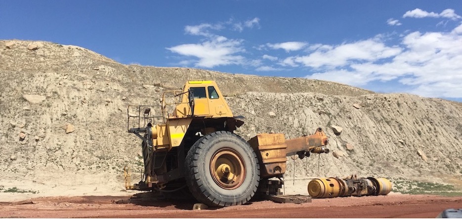A photo of a mine truck in decay on a coal mine site