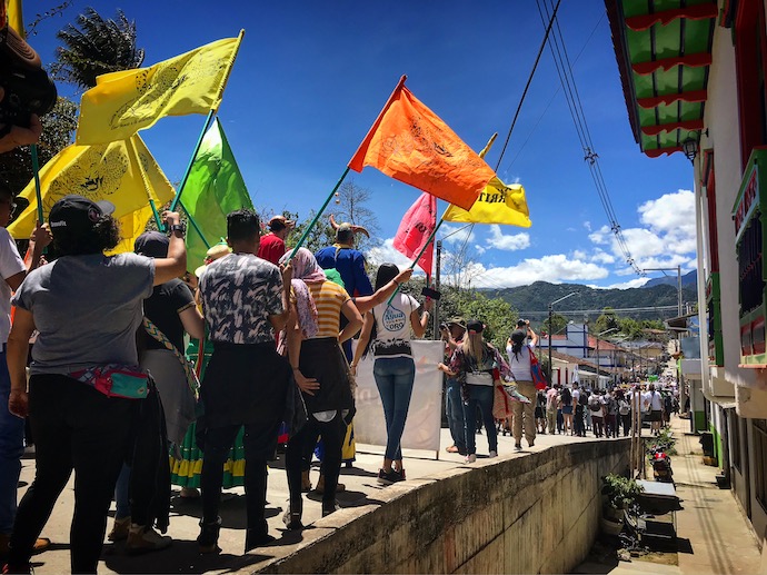 Demonstrators in Colombia marching and waving flags