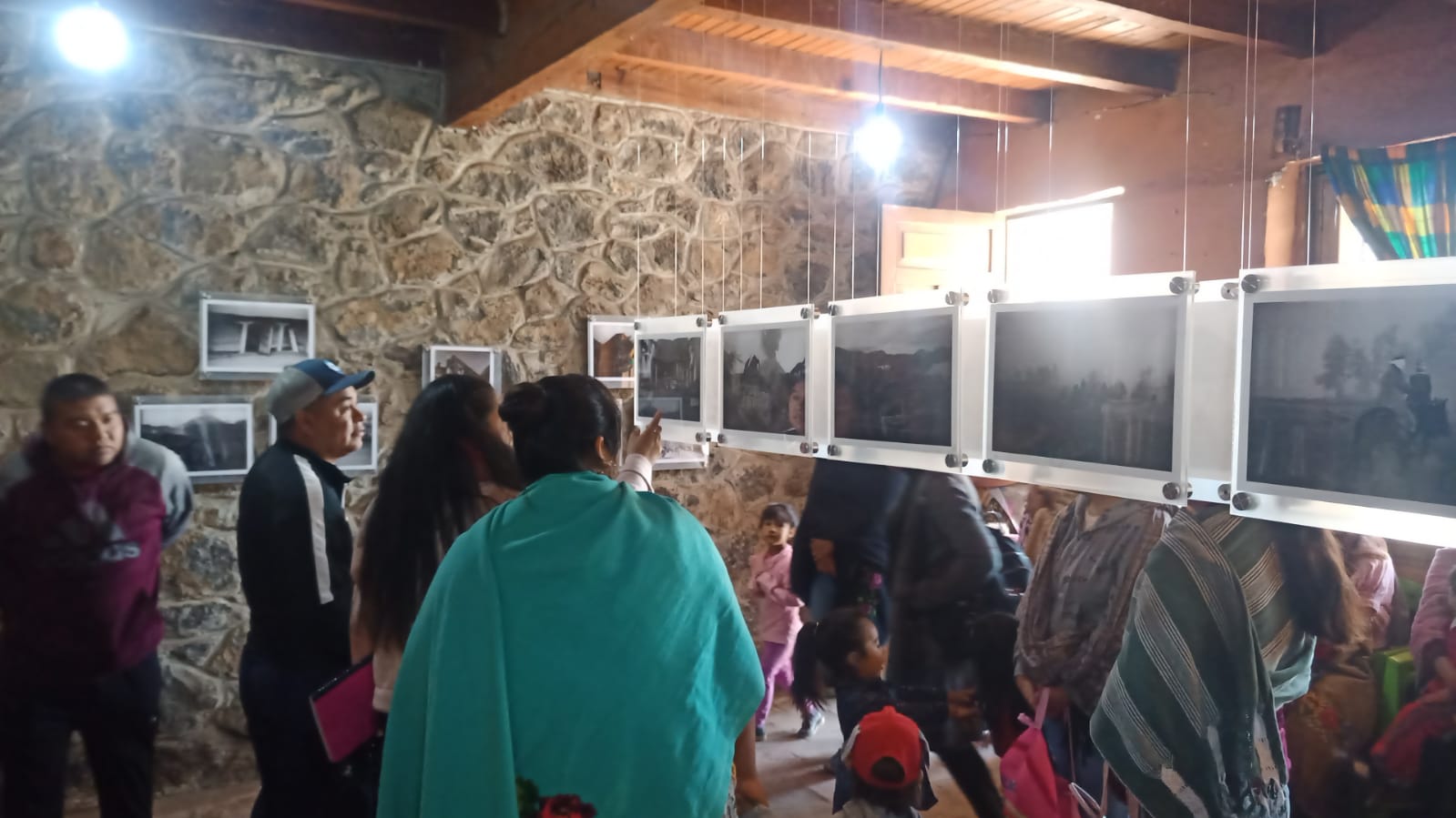 Photo exhibit with children and adults looking at the images