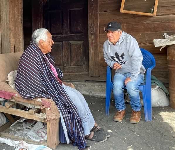 Man interviewing an old woman