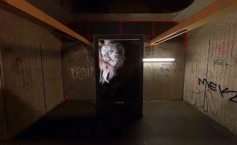 A still from an artwork depicting a Berlin subway station with an altered beauty ad