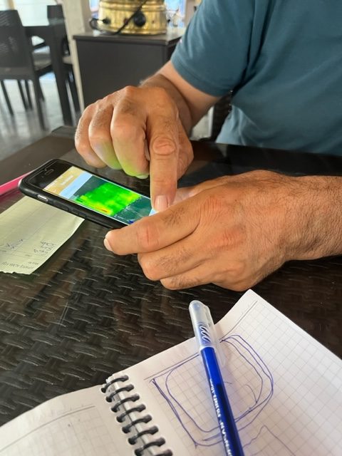 A picture of a farmer using a smartphone app.