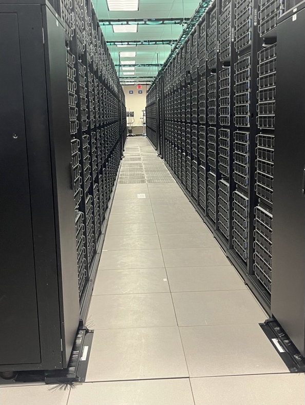 Rows of servers in a long hallway.