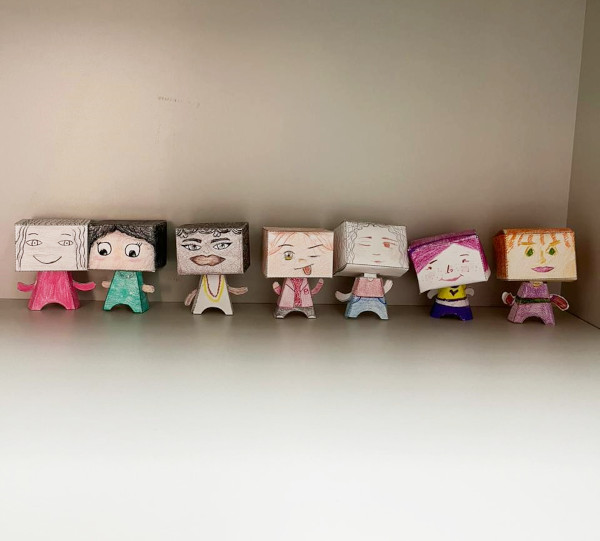 The image shows seven hand-drawn paper dolls on a white background.