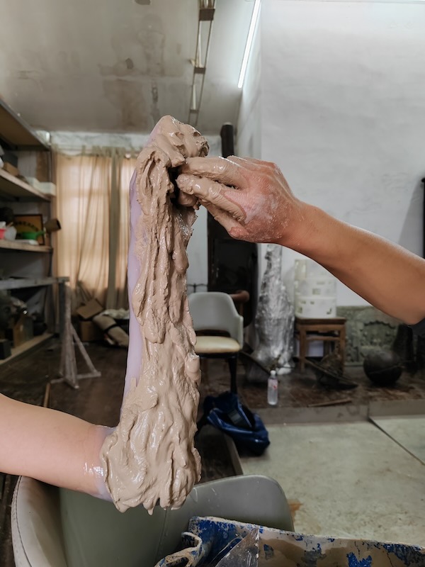 The image captures a moment of making mold while making sculpture.