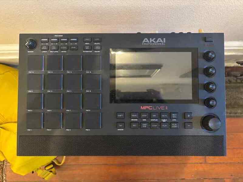 A black Akai MPC Live II portable production workstation with 16 RGB pads and touchscreen display