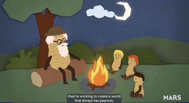 Grandpa Peanut sits at a campfire, opposite his three grand-nuts. Underneath the image is the text: "they're working to create a world that always has peanuts."