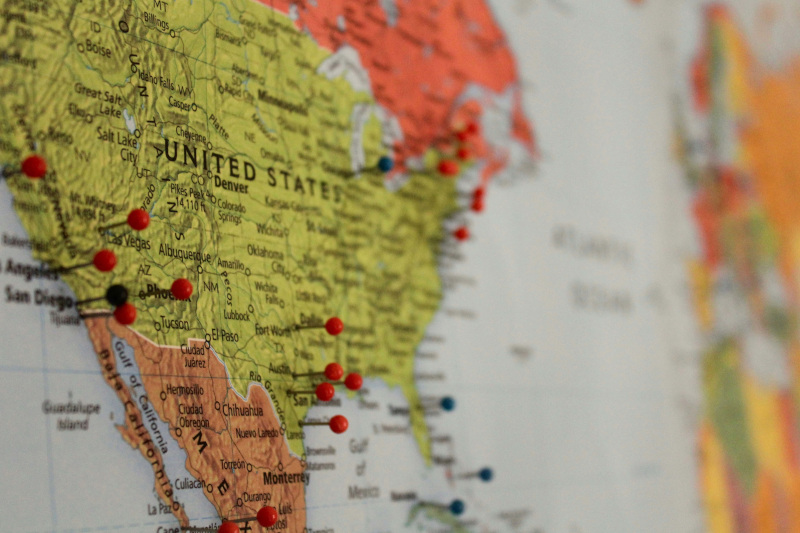 The image shows part of a map of the contiguous United States with red and green pins in different places.