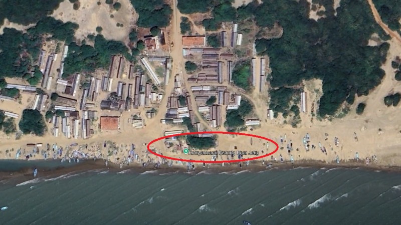 A topical view of Kodiyakarai along the shore. There are a few building structures and trees closer to shore. 