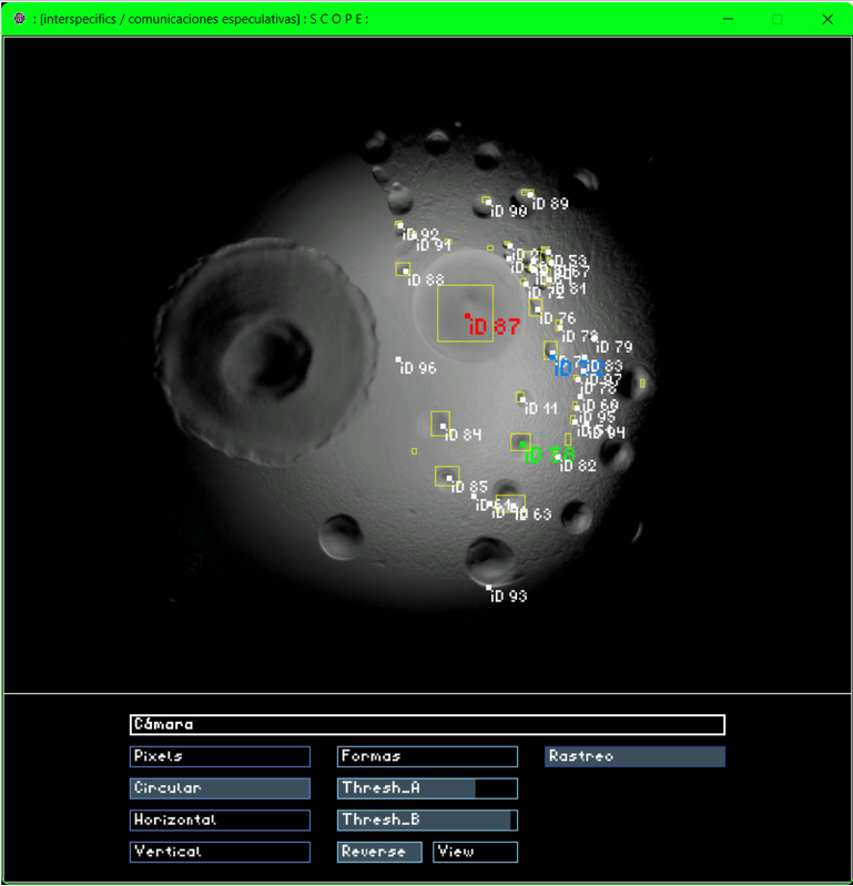 Screenshot of the Scope software showing the XY-plane tracking of three regions of a Paenibacillus vortex colony. The interface includes a left panel with numbered identifiers (ID 87–193) and adjustable controls such as Camera, Pixels, Thresh_A, Thresh_B, Formas, Rastreo, and View. On the plane, three colored trajectories represent the displacement of the selected regions. These movements in the two-dimensional plane are used in real time to modulate parameters of a sound synthesizer, translating biological behavior into audio.