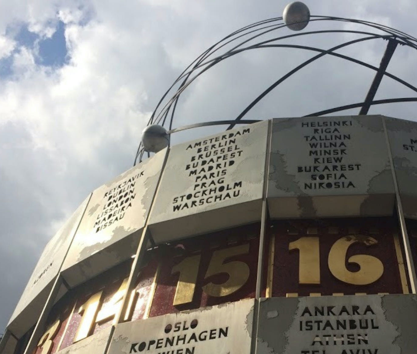 A fragment of the World Clock Statue at Alexanderplatz, Berlin, a large turret-style world clock. Showing the time at the moment for 3 different time zones in Europe