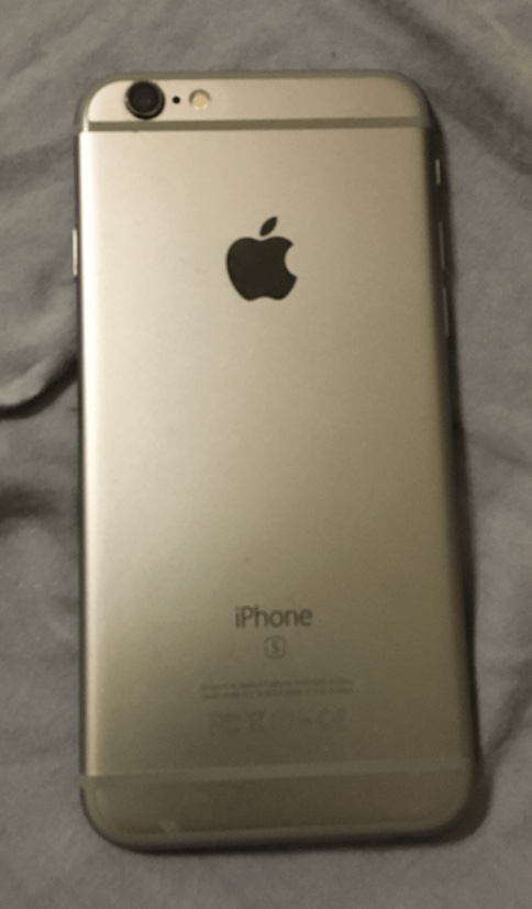 A silver iPhone photographed against a dark grey background