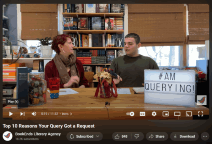 A screen shot of a youtube video. The video's title is "Top 10 reasons your query got a request". The frame has a female presenting person on the left and a male presenting person on the right. They are sitting at a wooden desk next to each other. Desk has various decoration. Behind them is a bookshelf with many books on its shelves.