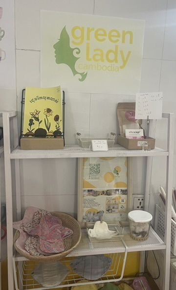 A display of Green Lady Cambodia products: sanitary pads, ‘Season to Blossom- Rohdoh Reak Lut Loh’ book and soap in a store in Phnom Penh.